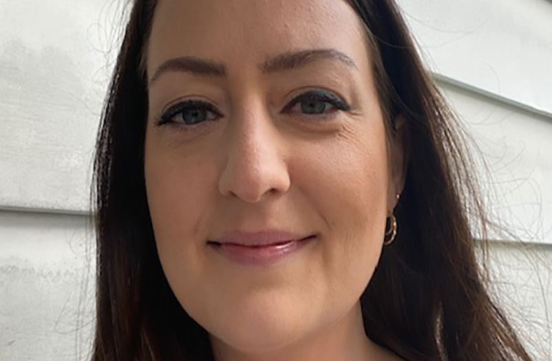 A closeup headshot of a woman with dark hair.